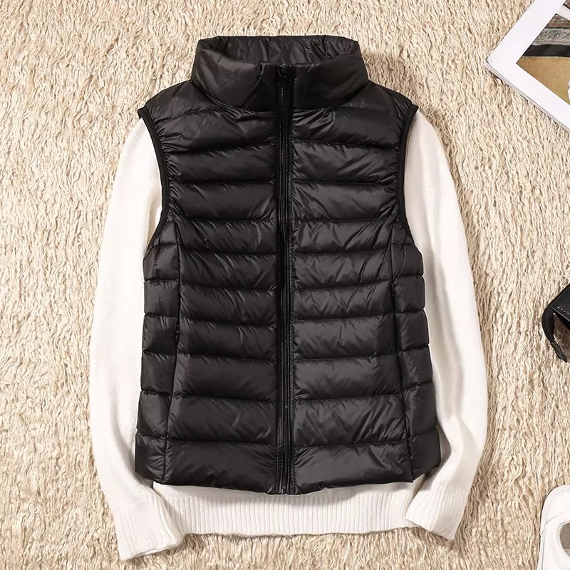 Women's cropped sleeveless light down puffer vest in neutral tone with quilted panels