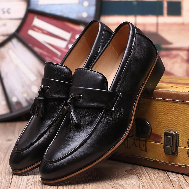 Brown leather loafers with moccasin-style stitched toe and classic slip-on silhouette