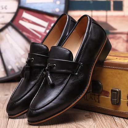 Brown leather loafers with moccasin-style stitched toe and classic slip-on silhouette