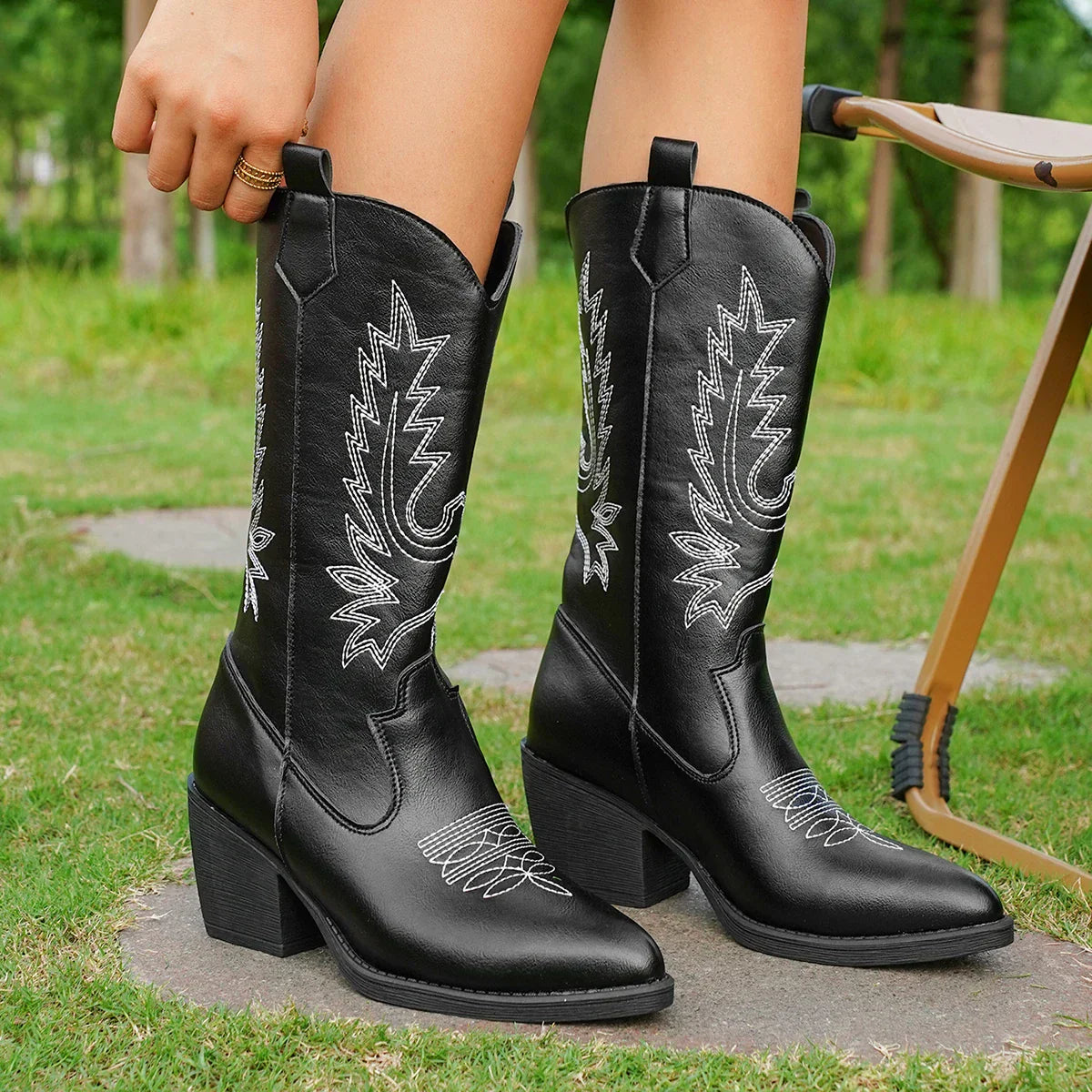 Women's black leather knee-high heeled boots with Western-inspired stitching and sleek polished finish