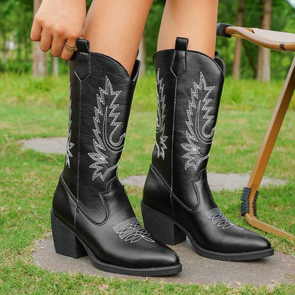 Women's black leather knee-high heeled boots with Western-inspired stitching and sleek polished finish