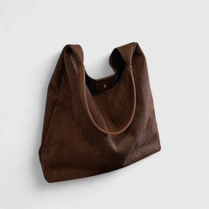 Minimalist white shoulder bag with clean lines, structured silhouette, and single adjustable strap