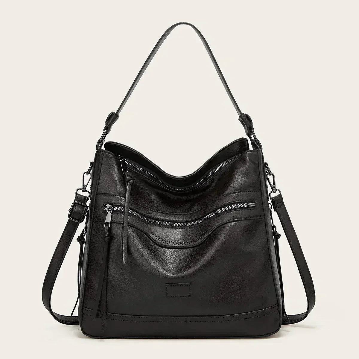 Black faux leather slouchy hobo bag with adjustable strap and multiple zip compartments