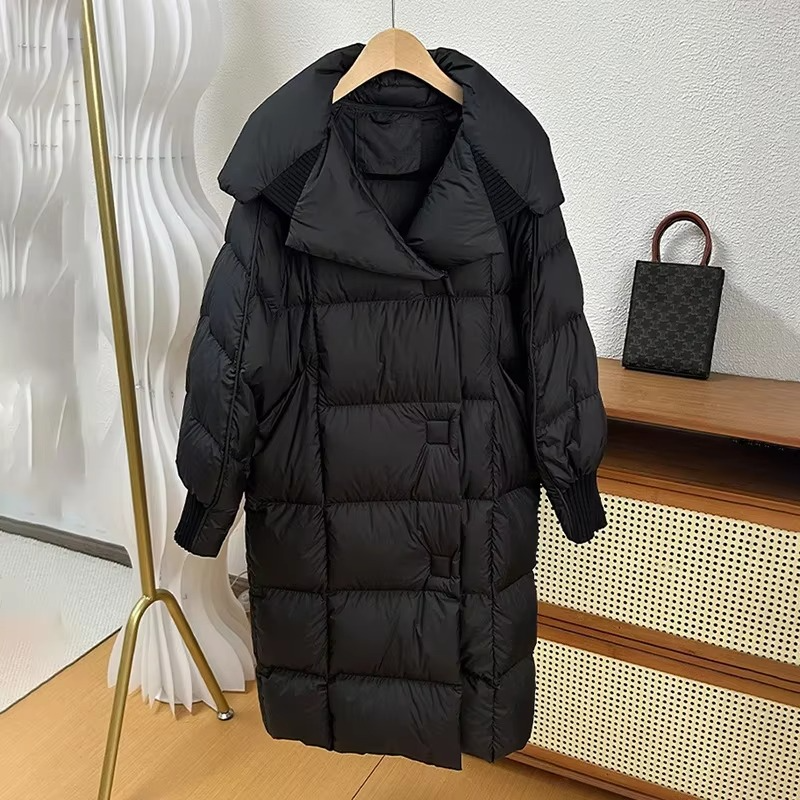 Women's oversized long puffer coat in solid color, warm down-filled winter outerwear with elegant silhouette