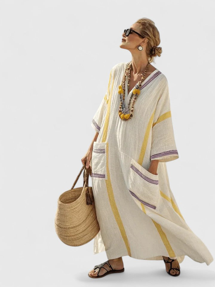Women's blue stripe kaftan maxi dress with deep V-neckline and flowing resort-style silhouette
