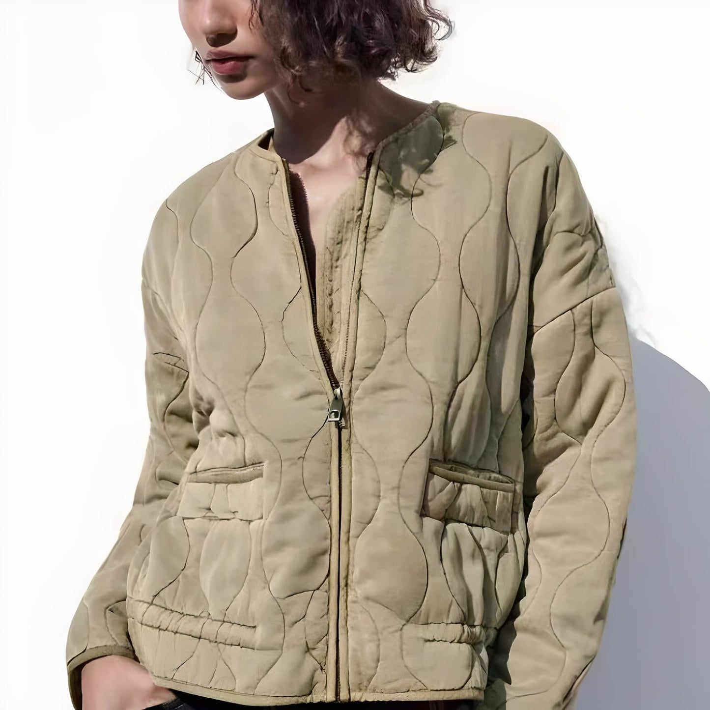Black quilted bomber jacket with padded insulation, zipper closure, and tailored fit