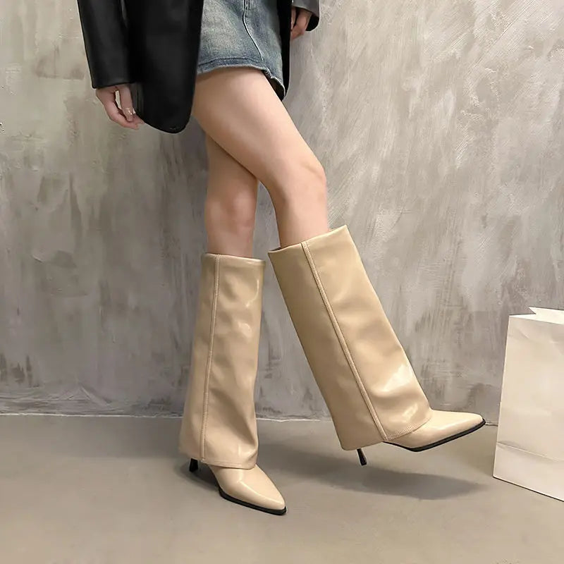Women's black leather thigh-high boots with structured shaft and bold buckle detail