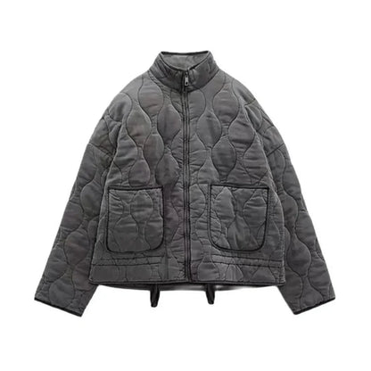 Black quilted bomber jacket with padded insulation, zipper closure, and tailored flattering fit