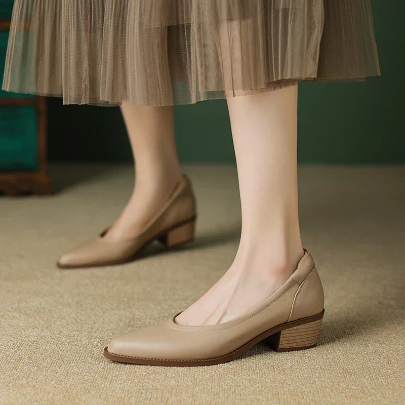 Women's pointed toe block heel pumps in classic slip-on style with stable mid-height heel for all-day wear