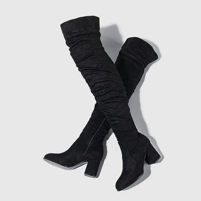 Black over-the-knee women's heeled boots with block heel and sleek elongating silhouette