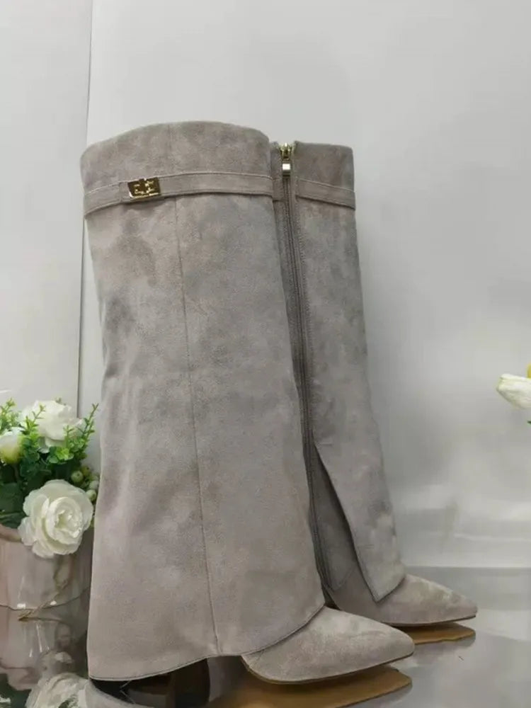 Women's black leather thigh-high boots with statement buckle detail, sleek sculpted silhouette