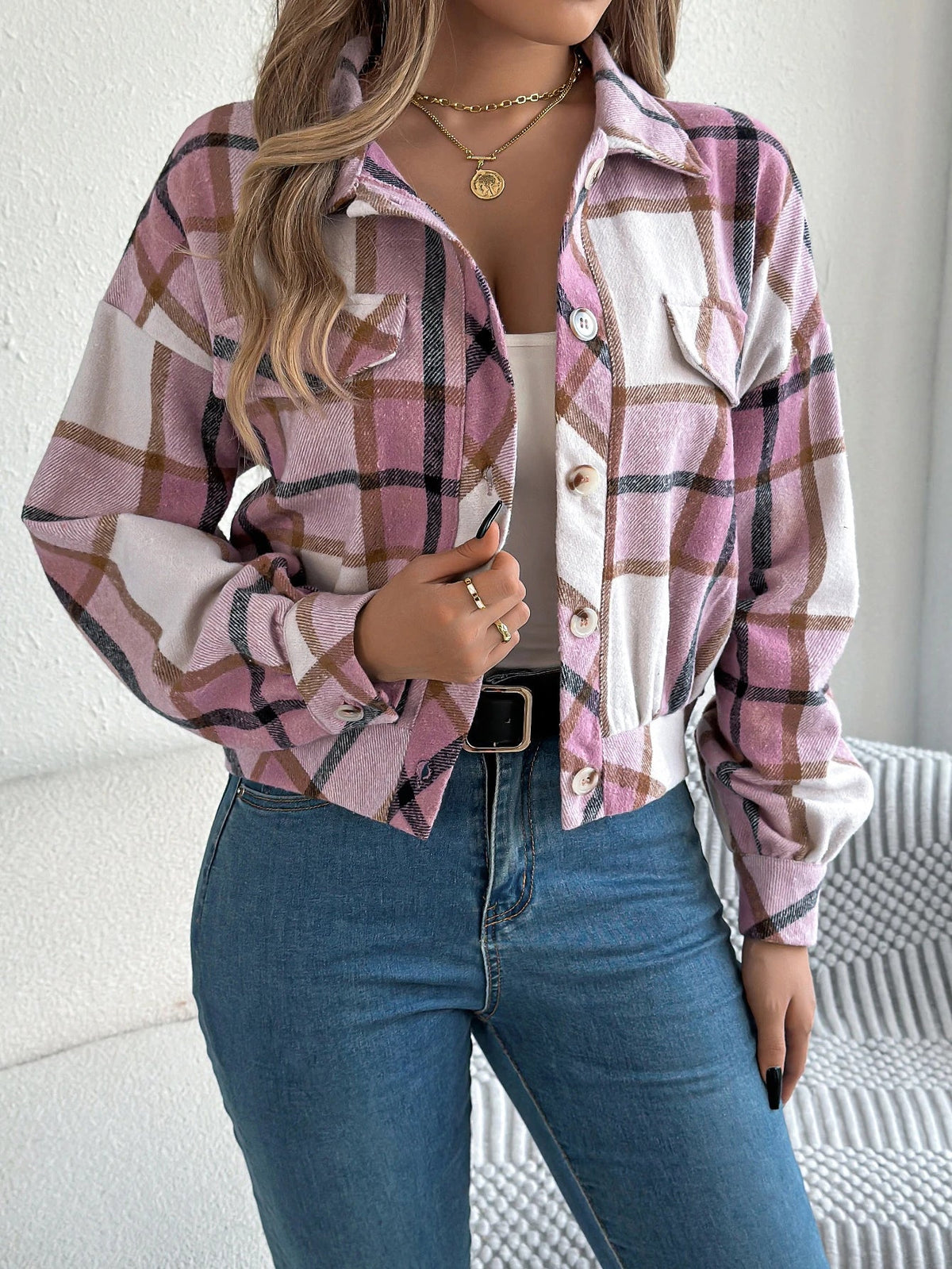 Cropped plaid jacket in warm tones with brushed fabric, draped sleeves, and faux horn buttons
