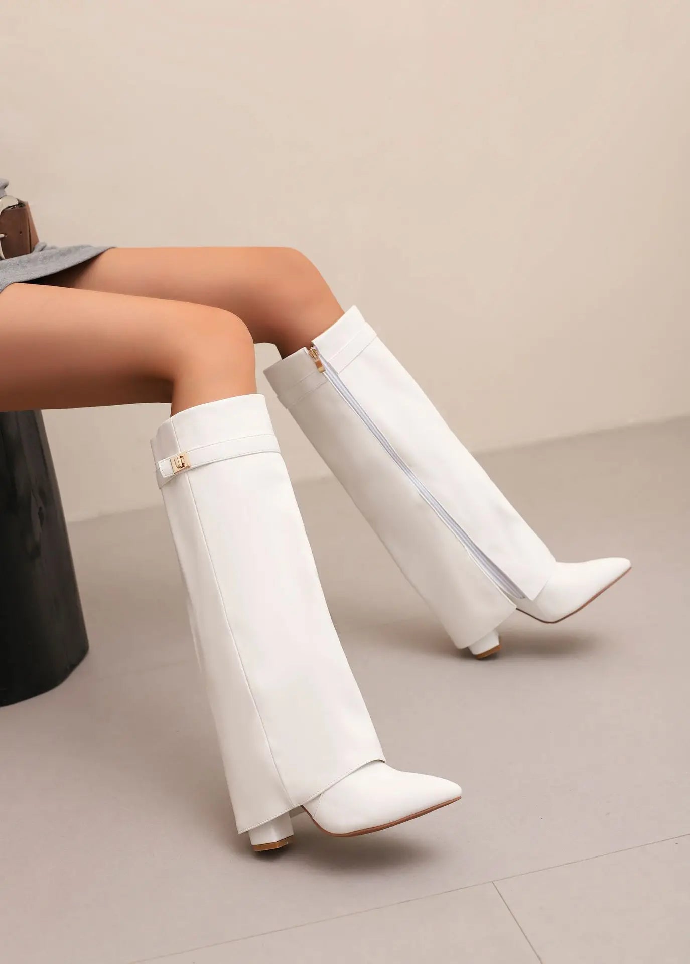 Women's black leather thigh-high boots with bold buckle detail, sleek silhouette for day-to-night style
