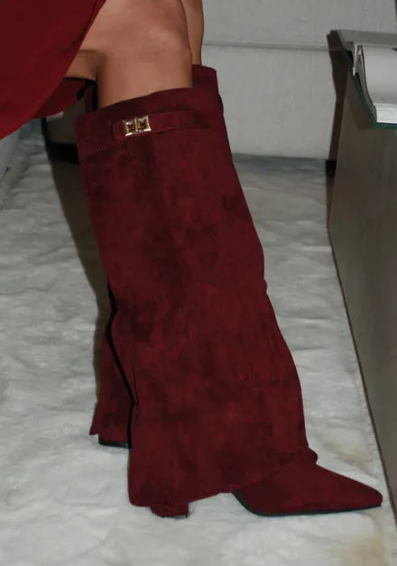 Women's black leather thigh-high boots with bold buckle detail, sleek silhouette for day-to-night style