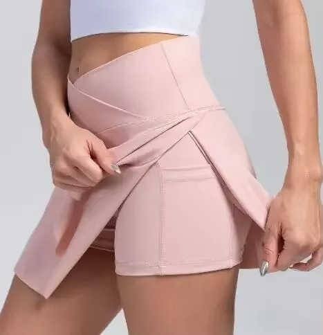 White high waist tennis skirt with built-in shorts, pockets, and compression fit for women