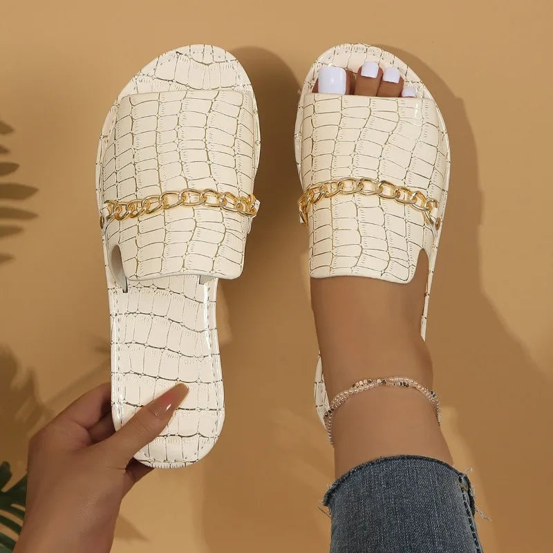 Women's croc-embossed sandals in neutral tone, sleek silhouette with quiet luxury texture