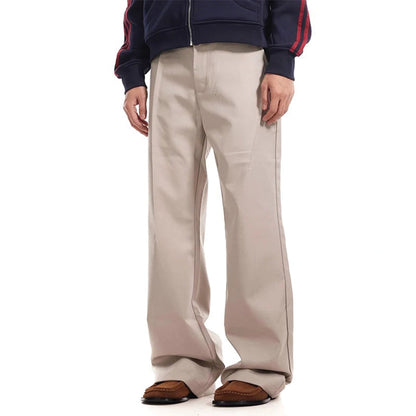 Beige flared straight-leg trousers with pleated front and zipper fly, vintage-inspired deconstructed cut