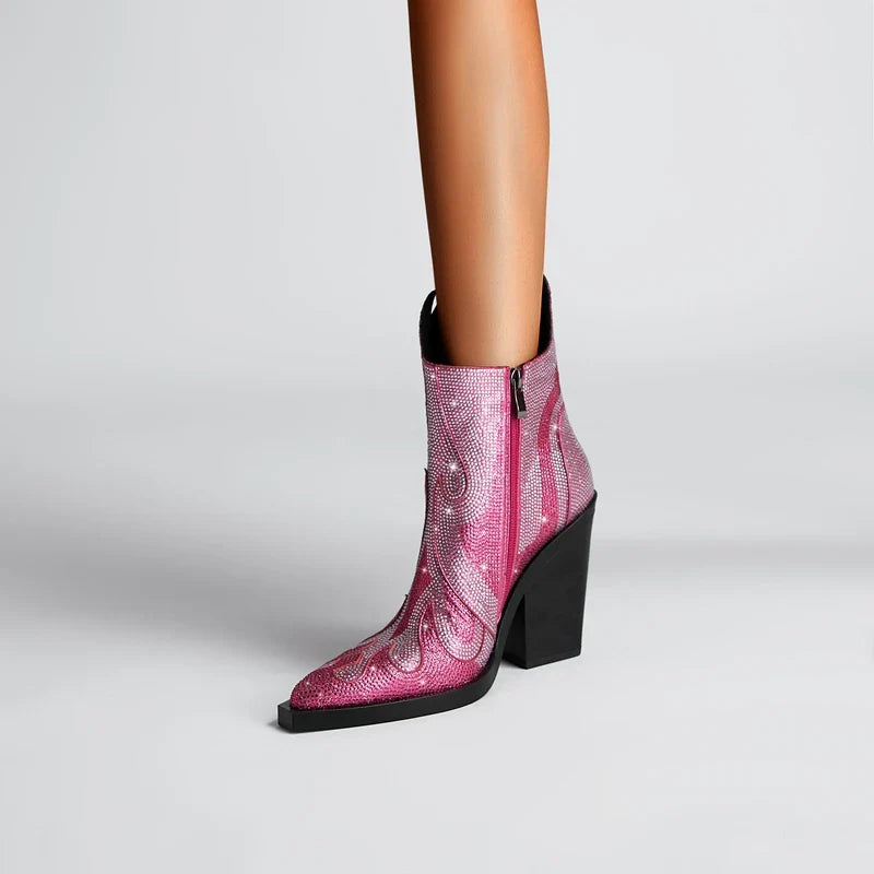 Black ankle boots with flame silhouette cutout shaft, rhinestone embellishments, and bold diva heel design