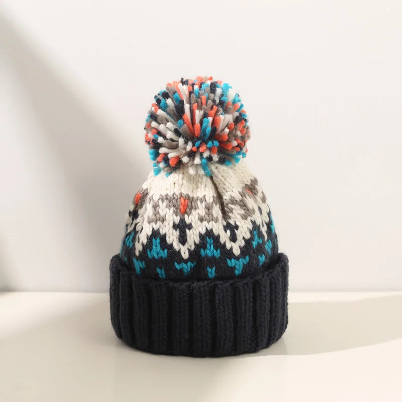 Cozy knit beanie with snowflake pattern and fluffy pom, festive winter style in neutral tones
