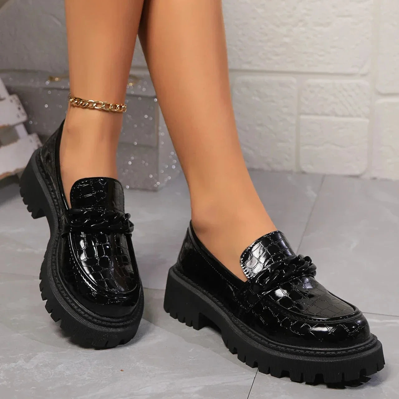 Women's black croc-embossed platform loafers with satin-gloss finish and chunky sole
