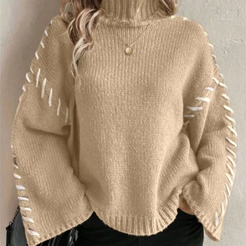 Carmine red soft-knit pullover sweater with relaxed high neck and contrast sleeve stitching
