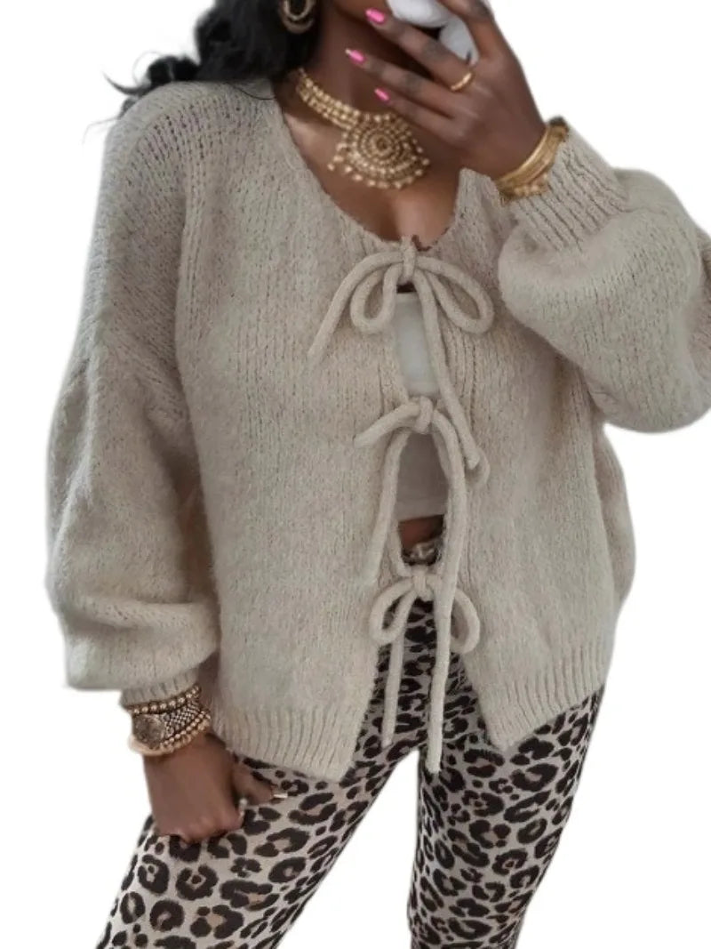 Women's chunky knit cardigan in cozy winter style featuring a knotted front tie detail