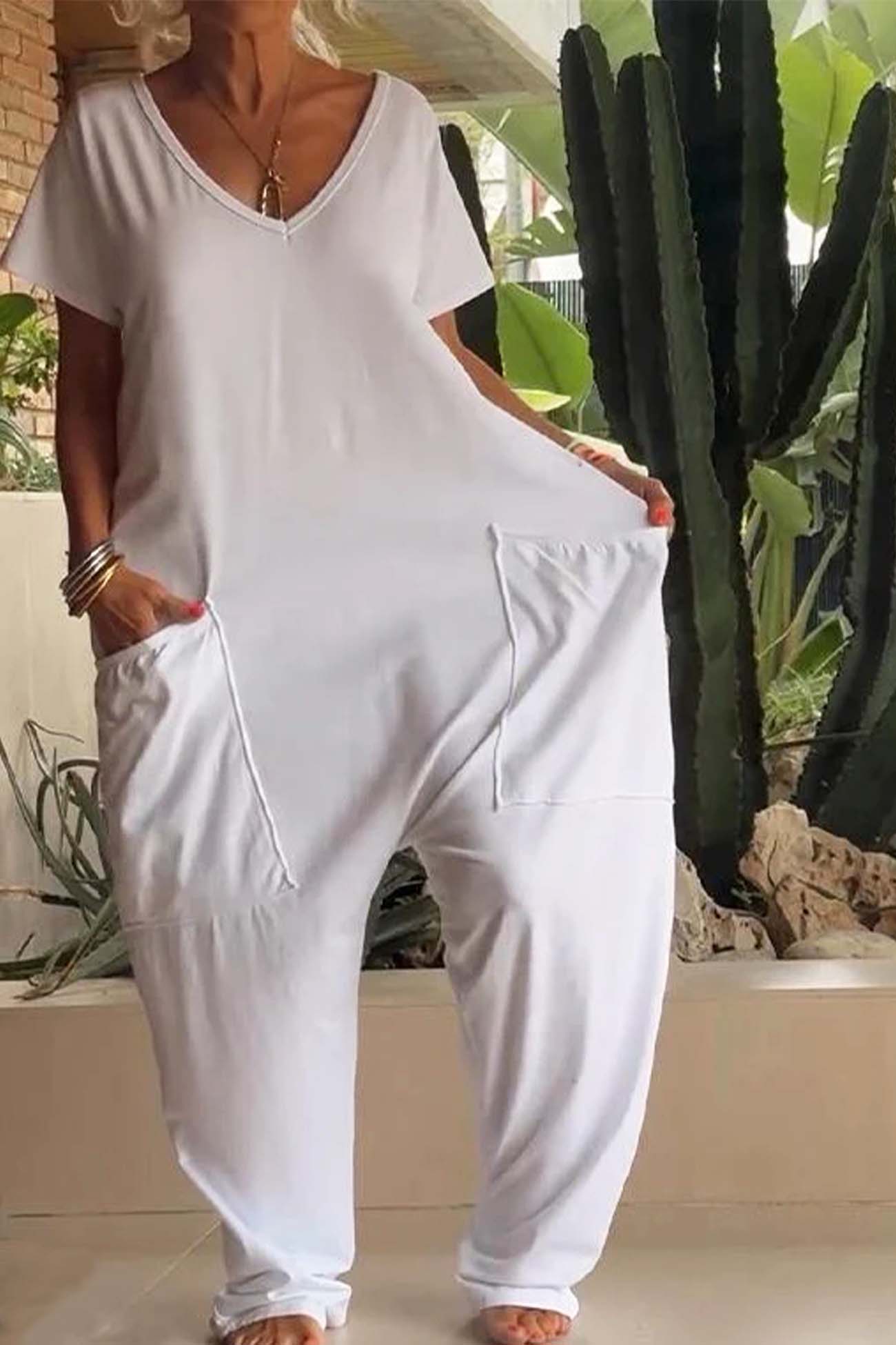 Women's loose V-neck short sleeve jumpsuit with drop-crotch silhouette and oversized front pockets