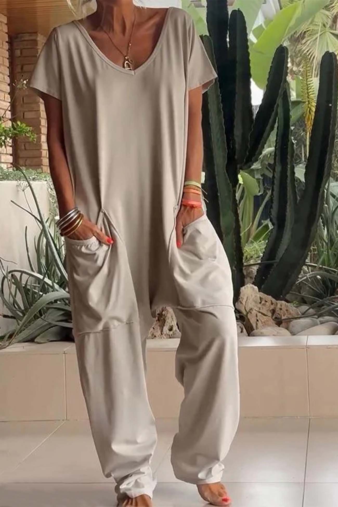 Women's loose V-neck short sleeve jumpsuit with drop-crotch silhouette and oversized front pockets