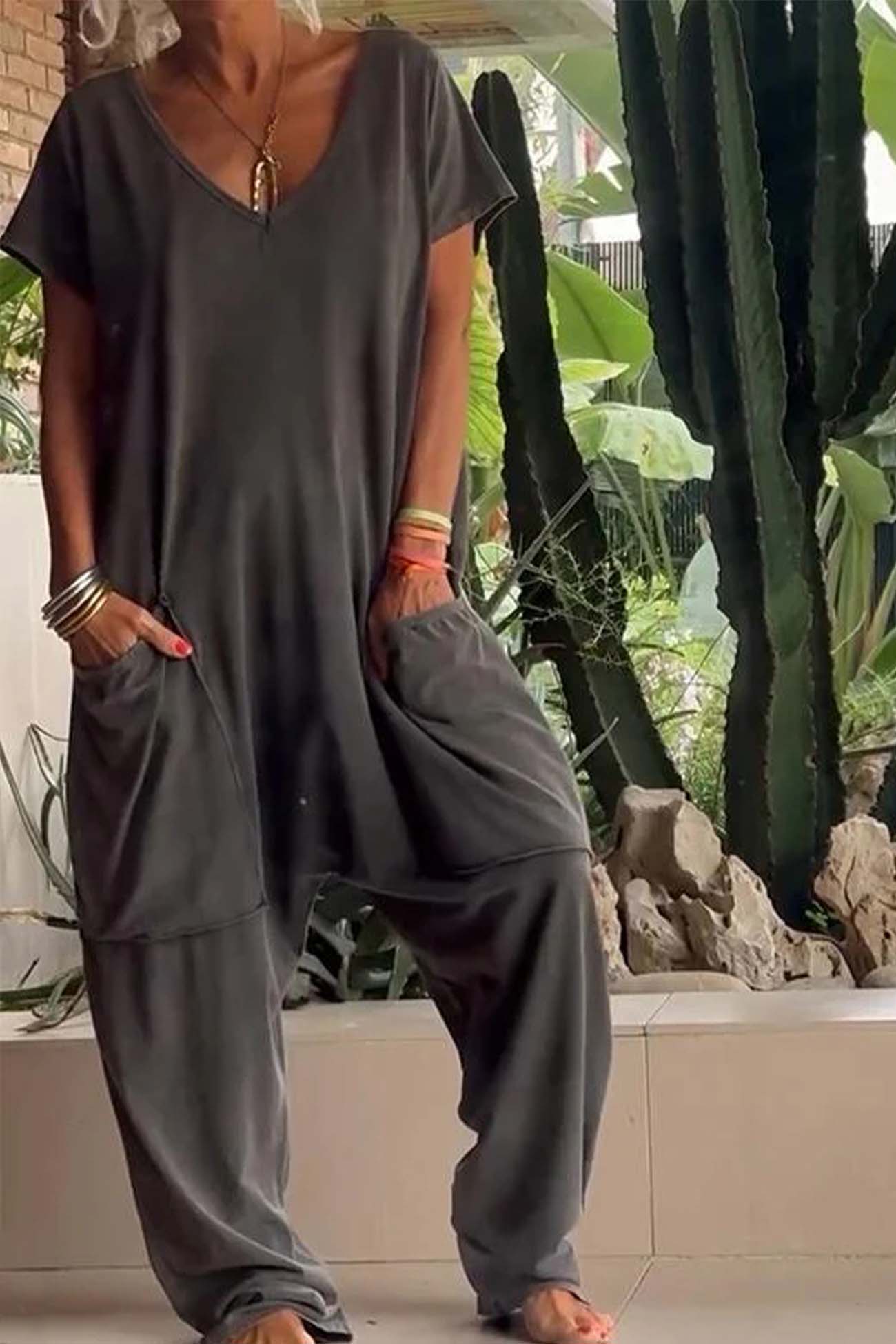 Women's loose V-neck short sleeve jumpsuit with drop-crotch silhouette and oversized front pockets