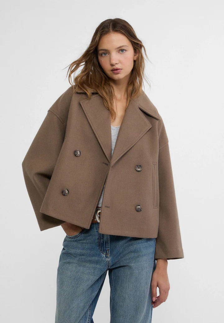 Black short double-breasted cropped jacket with classic button closure for polished everyday style