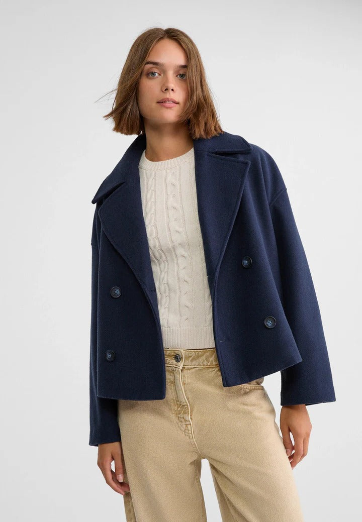 Black short double-breasted jacket with cropped silhouette and classic polished tailoring for versatile wear
