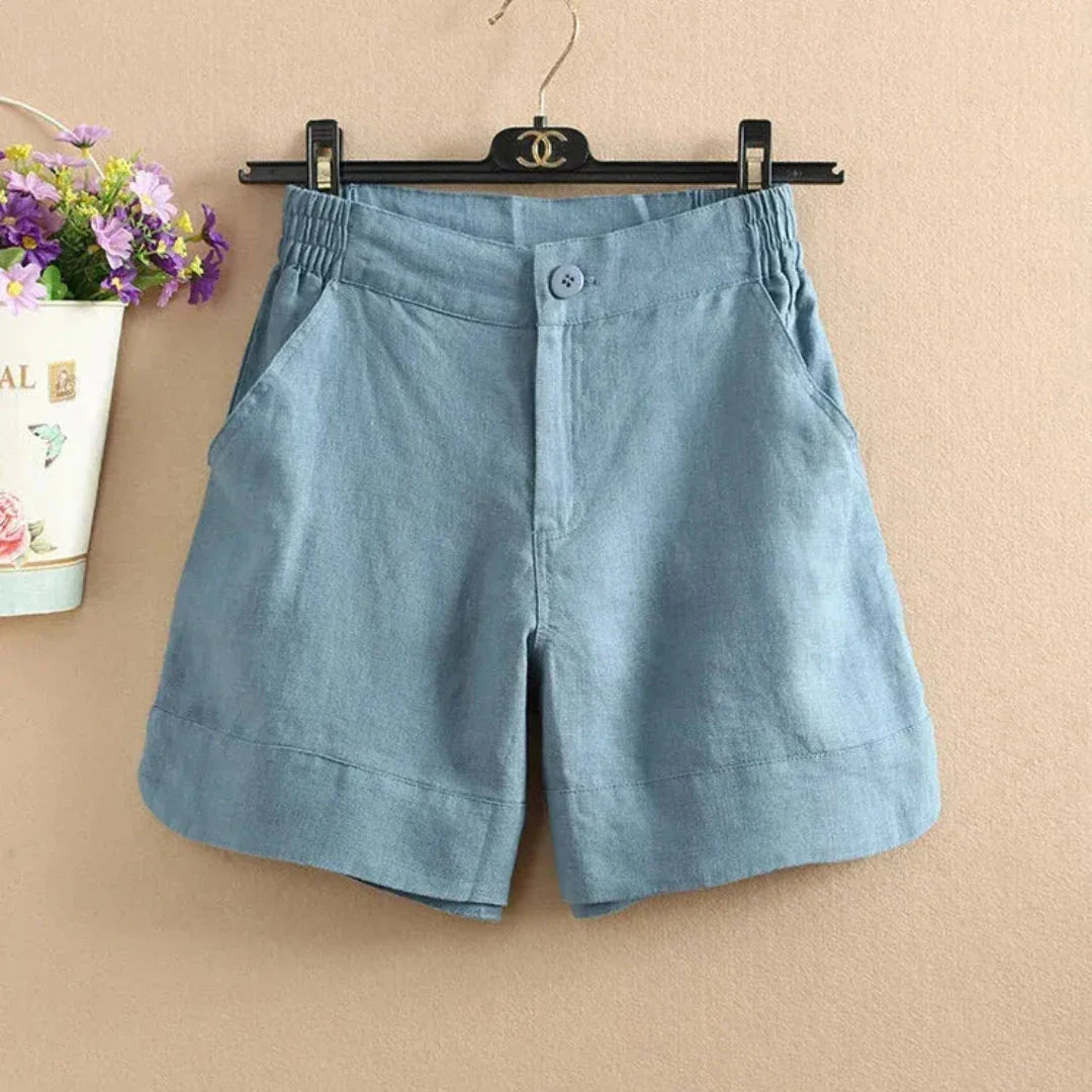 Women's relaxed-fit linen shorts with elastic waistband, front button, and side pockets for warm-weather style