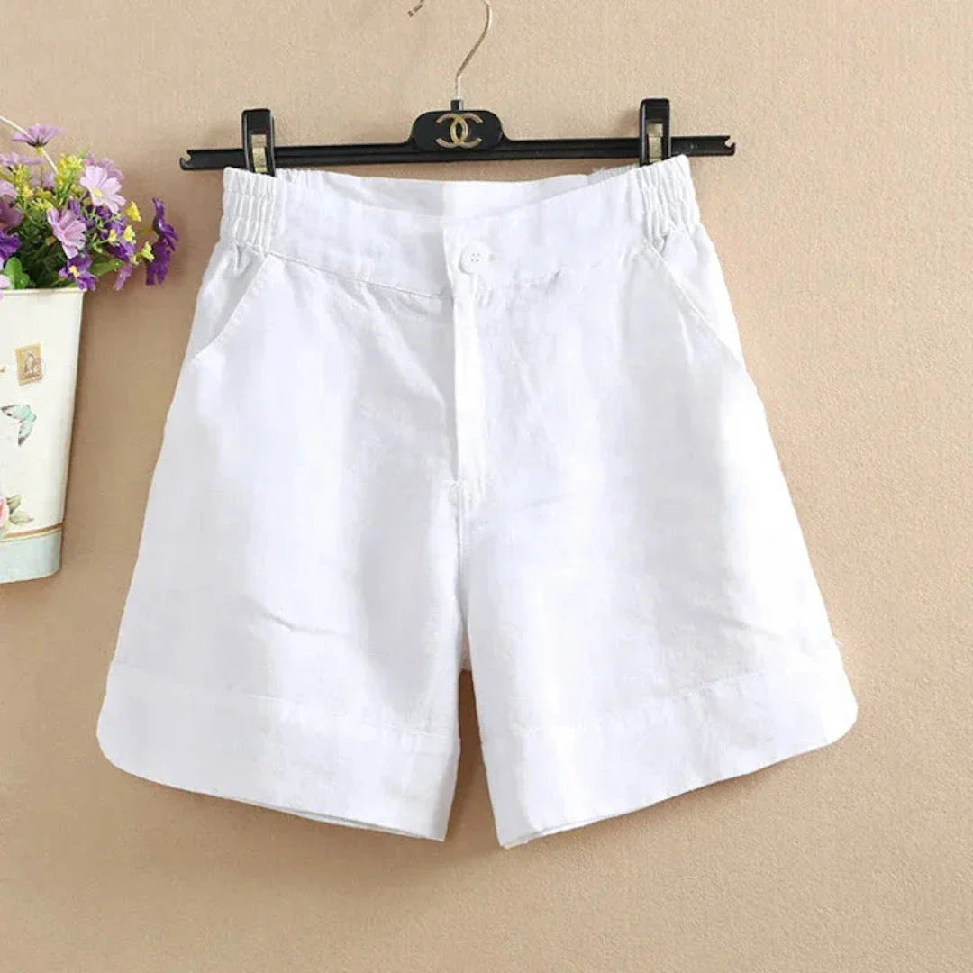 Women's relaxed-fit linen shorts in natural tan with elastic waistband and front button closure