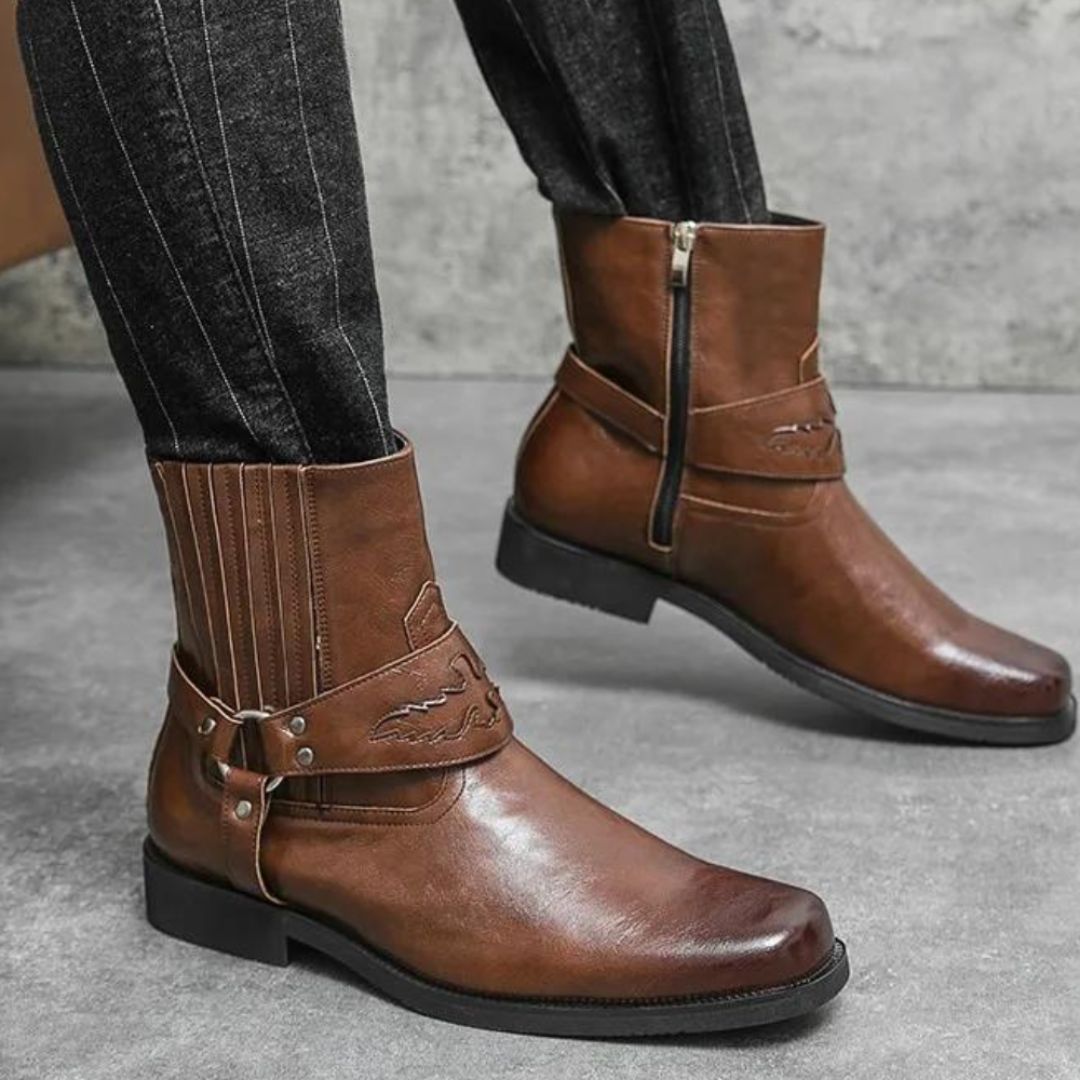 Brown faux leather Western boots with strap detail, inner zipper, and rubber outsole for street style