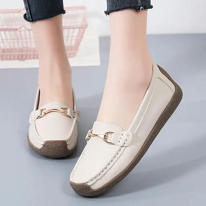 Women's slip-on moccasin flats in neutral tones, rounded toe, clean stitching, faux leather upper