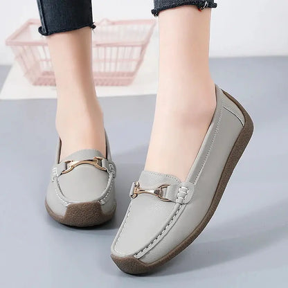 Women's slip-on moccasin flats in neutral faux leather with clean stitching and rounded toe