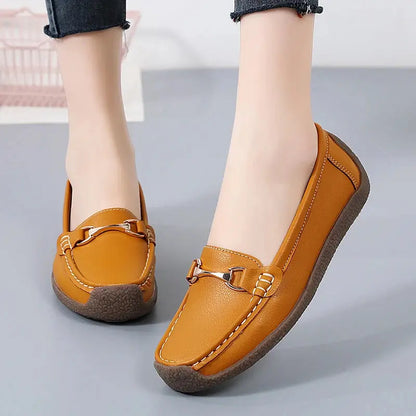 Women's slip-on moccasin flats in neutral faux leather with clean stitching and rounded toe