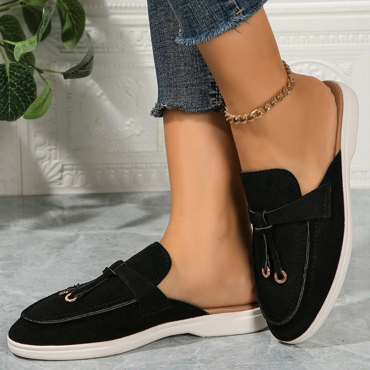 Women's white slip-on casual sneakers with textured synthetic upper and lightweight rubber sole