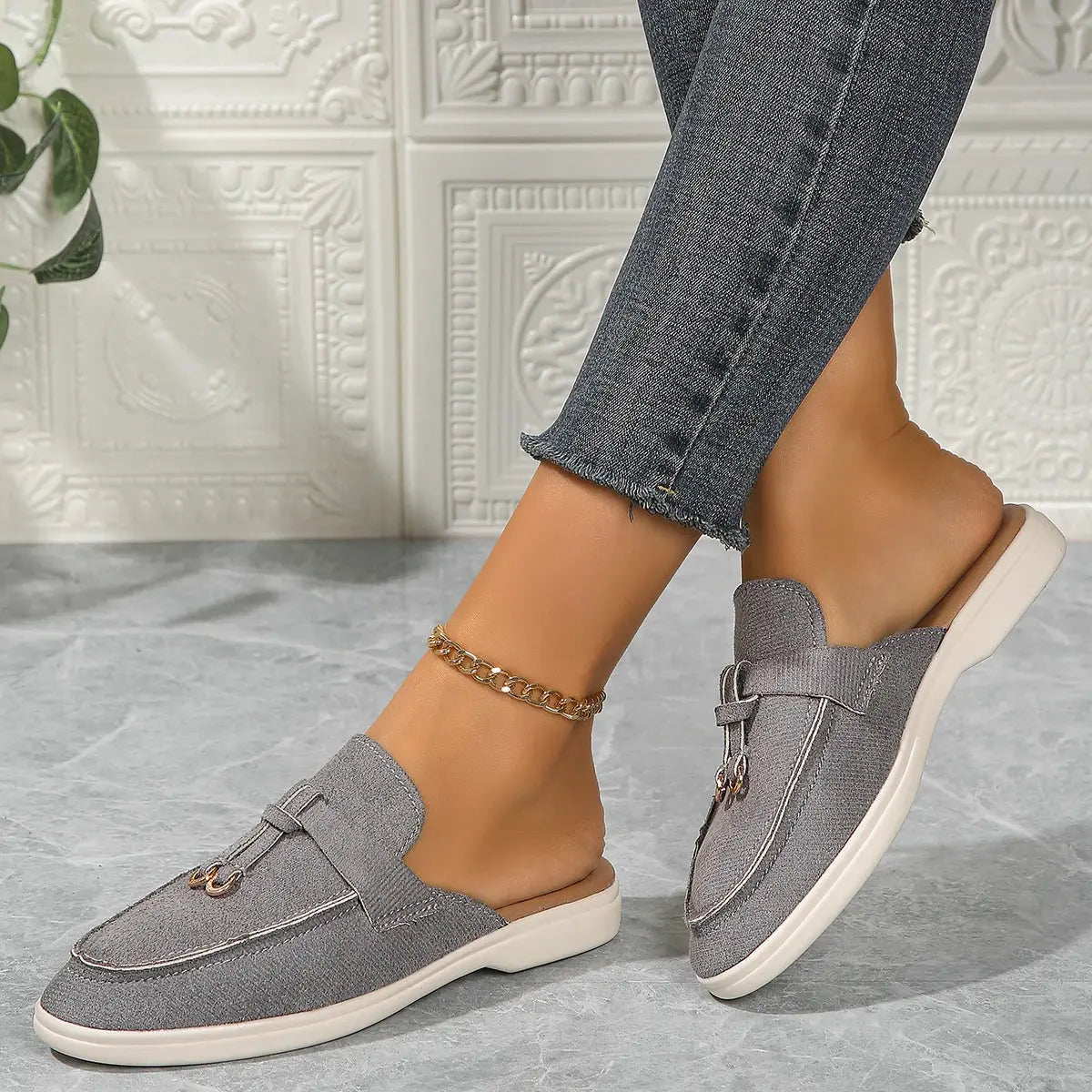 Women's white slip-on casual sneakers with lightweight rubber sole and textured synthetic upper