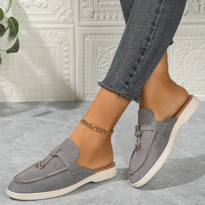 Women's white slip-on casual sneakers with lightweight rubber sole and textured synthetic upper
