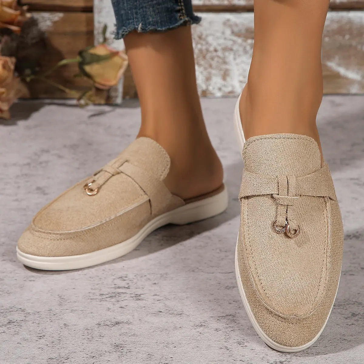 Women's white slip-on casual sneakers with lightweight rubber sole and textured synthetic upper