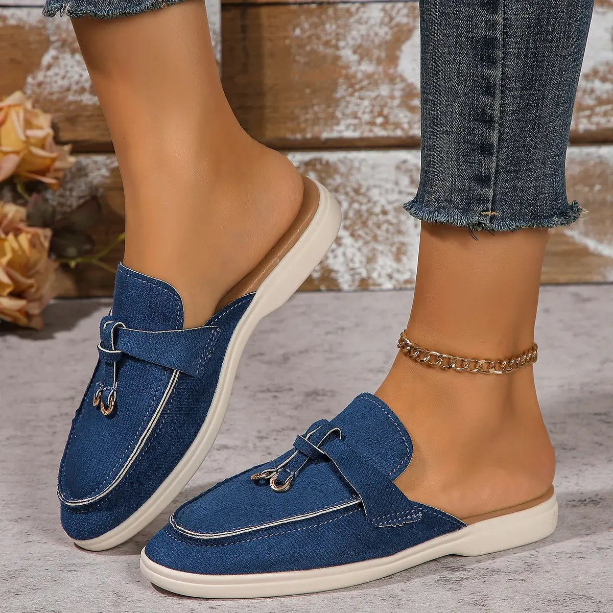 Women's white slip-on casual sneakers with lightweight rubber sole and textured synthetic upper