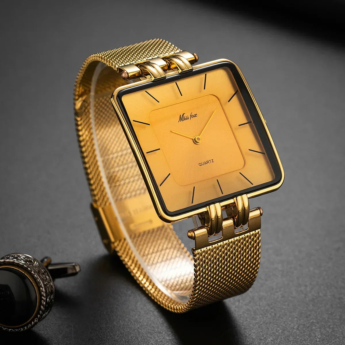 Statement bold gold mesh watch with geometric dial and gleaming radiant metalwork band