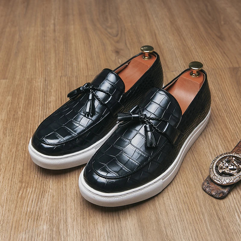 Black embossed crocodile leather loafers with tassel accent and bold thick white sole