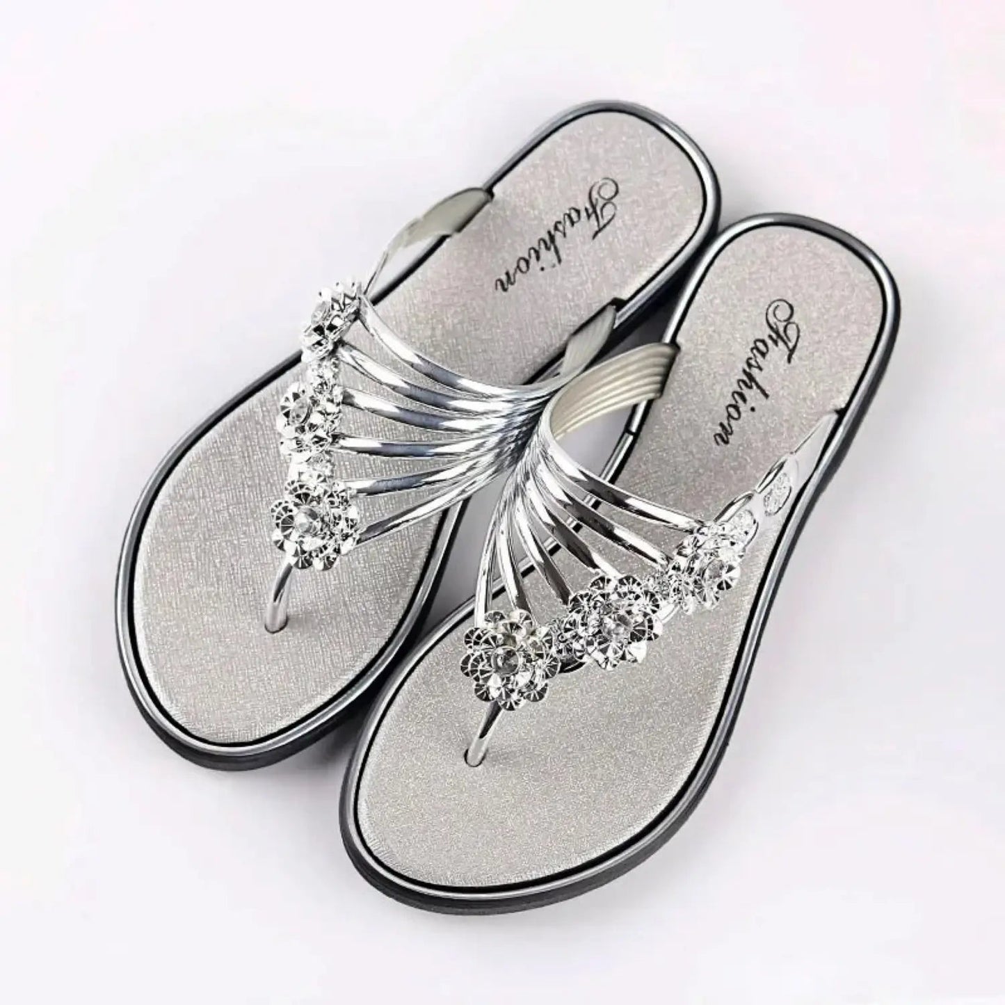 Women's gold-tone strappy sandals with floral rhinestone embellishments, chic summer footwear
