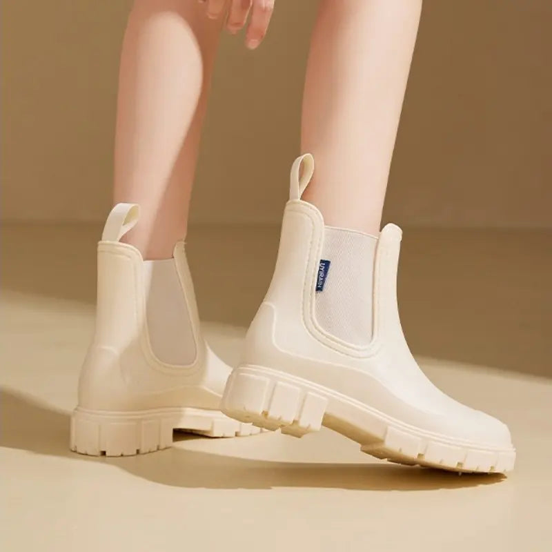 Women's black ankle rain boots, waterproof PVC construction with sleek modern silhouette