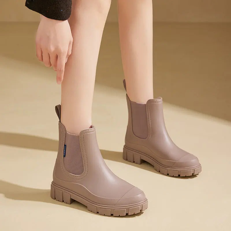 Women's black ankle rain boots, waterproof PVC construction with sleek modern silhouette