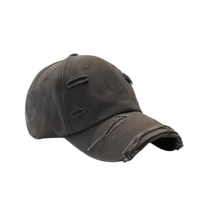 Vintage distressed baseball hat in cotton with extended brim and rugged ripped detailing