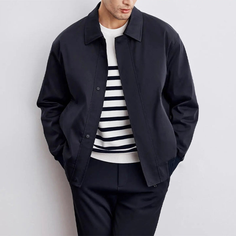 Navy blue bomber jacket with turn-down collar, ribbed cuffs, and sleek minimalist silhouette