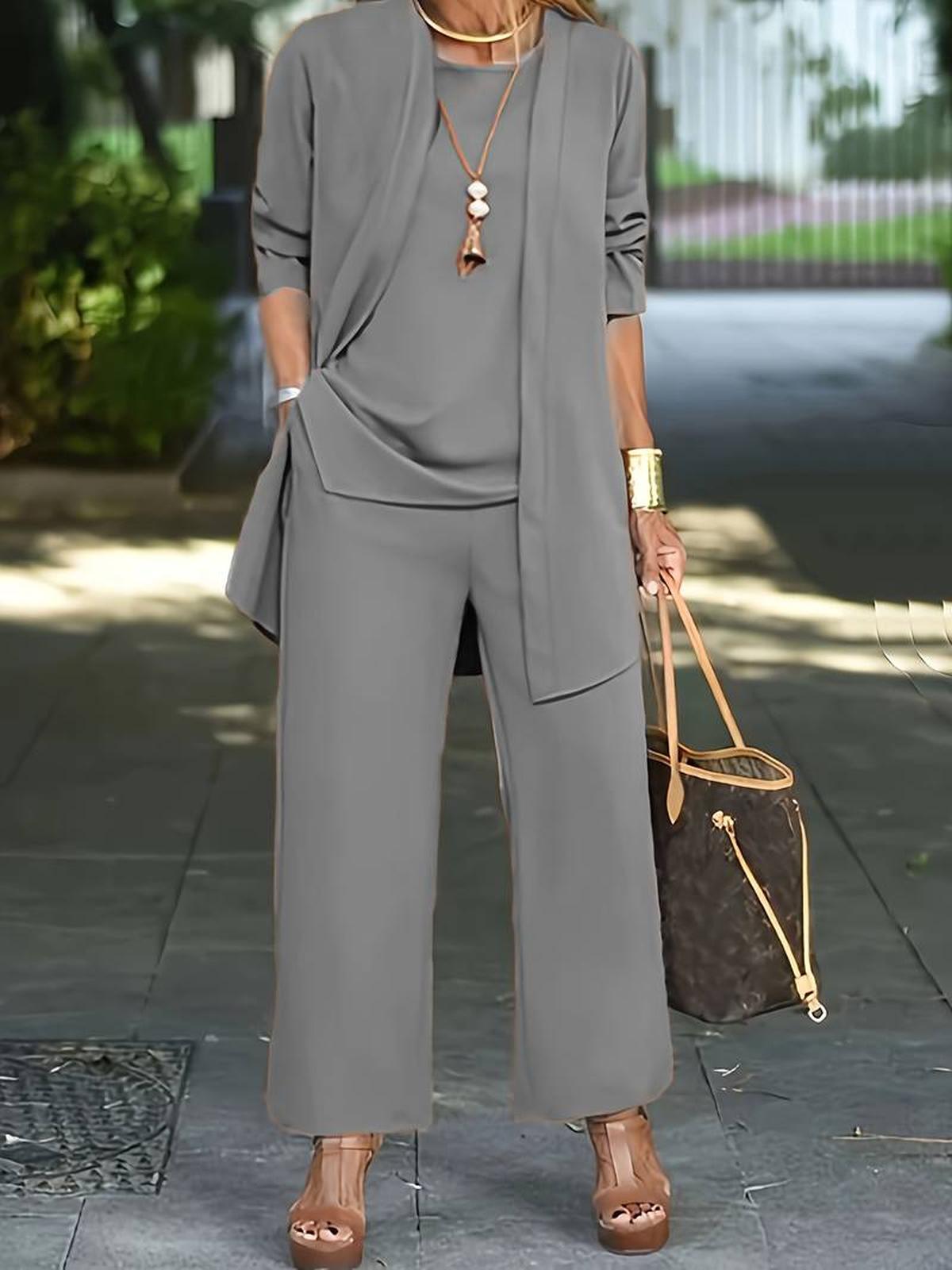 Women's three-piece relaxed outfit set with flowing top, wide-leg pants, and lightweight outer layer